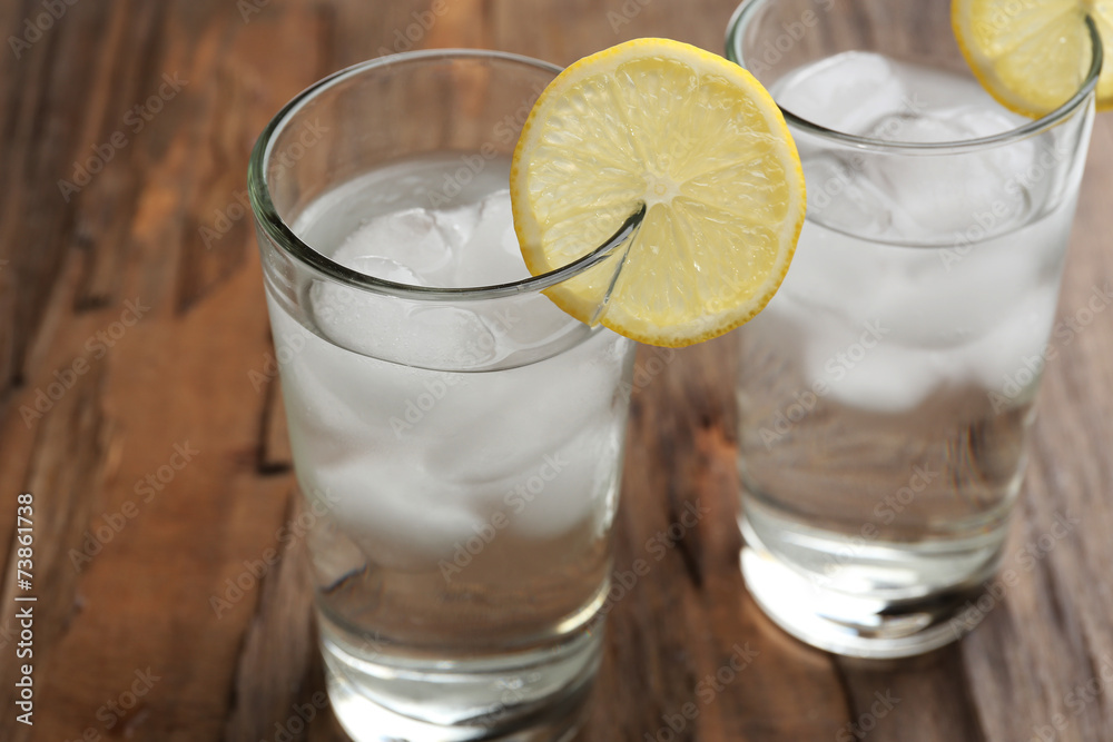 Glasses with ice cubes on wooden table Glasses with ice cubes on wooden table