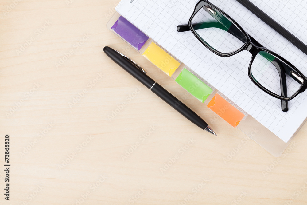 Office table with glasses, blank notepad and pencil Office table with glasses, blank notepad and pencil