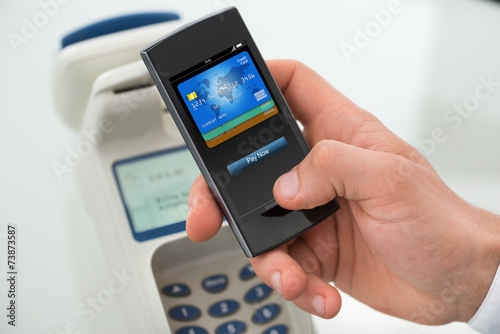 Businessman's Hand Paying Through Mobilephone