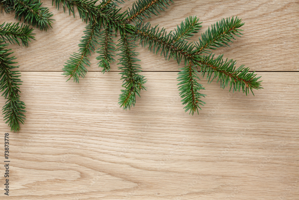 christmas tree branch on oak table christmas tree branch on oak table