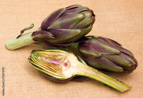 Artichoke cut in half on placemat jute photo