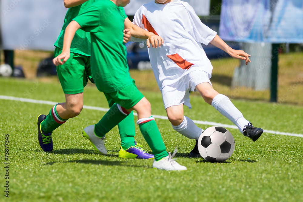 Football soccer match for children. Boys playing football game