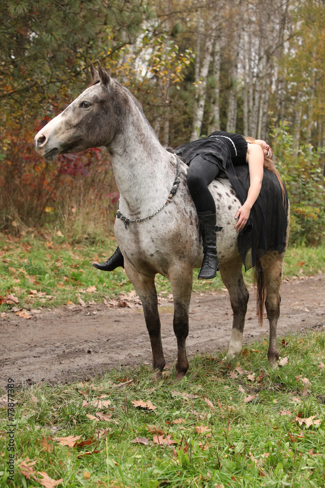Fototapeta premium Young girl with appaloosa horse in autumn