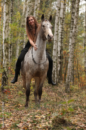 Young girl with appaloosa horse in autumn © Zuzana Tillerova