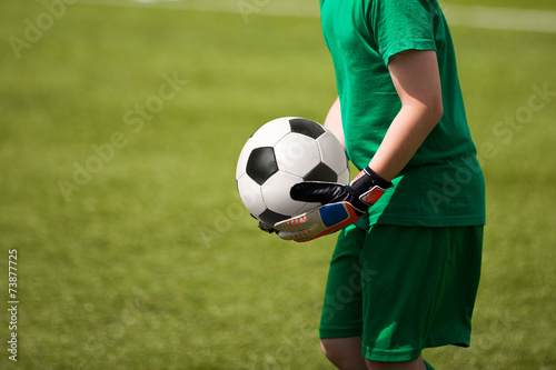 Child goalkeeper keeping the ball © matimix