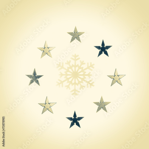 Snowflake surrounded by gold and silver stars