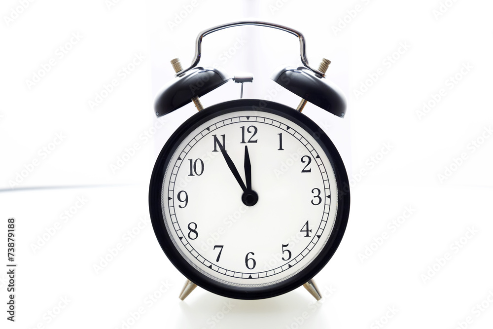 Oldfashioned black glossy alarm clock showing 5 to 12 Oldfashioned black glossy alarm clock showing 5 to 12