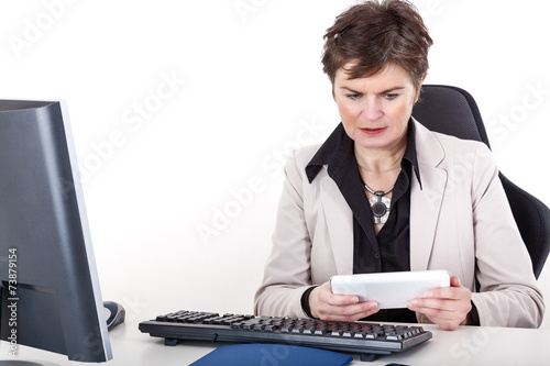 Businesswoman in office with tablet PC