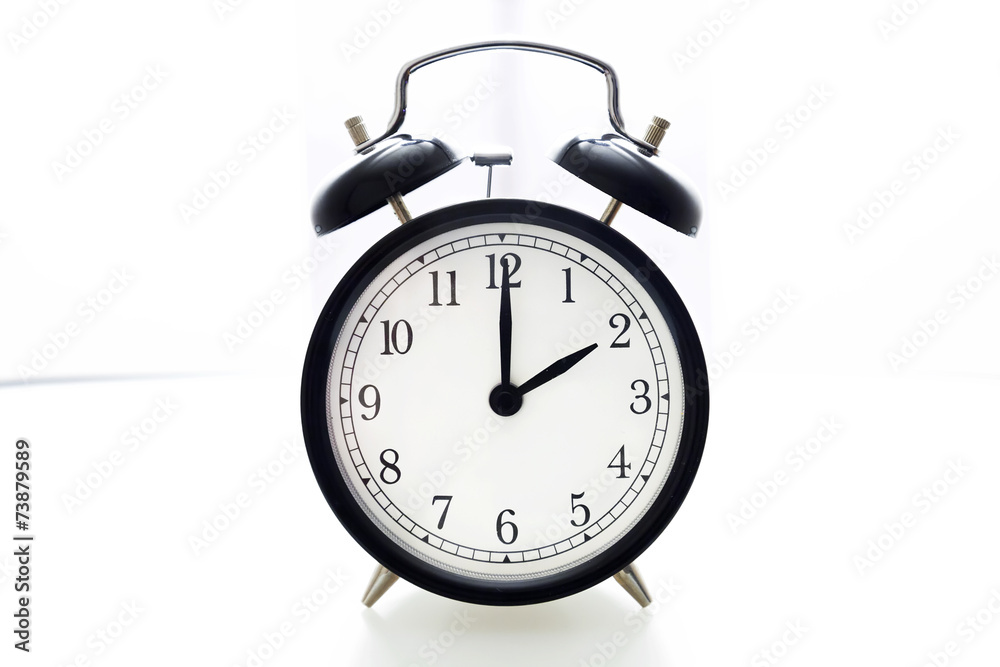 Oldfashioned black glossy alarm clock showing 2 o'clock Oldfashioned black glossy alarm clock showing 2 o'clock