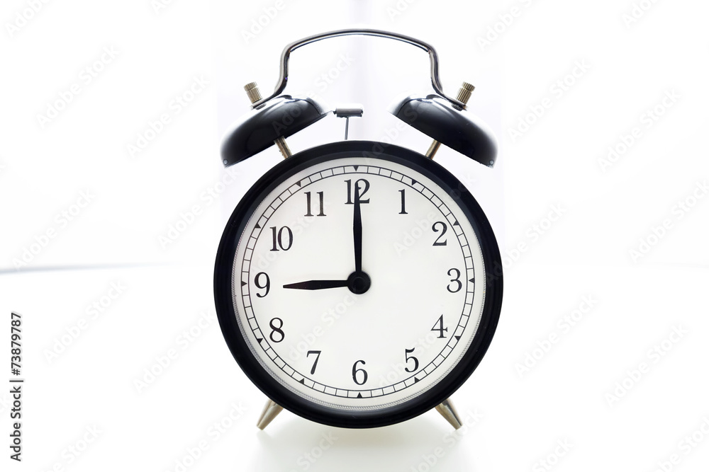 Oldfashioned black glossy alarm clock showing 8 o'clock Oldfashioned black glossy alarm clock showing 8 o'clock