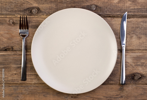 Empty plate on wooden background