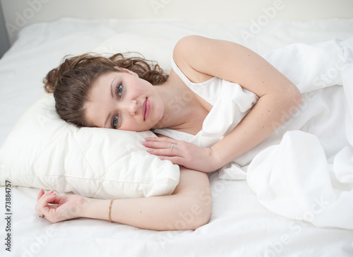 Beautiful young woman asleep, on white background