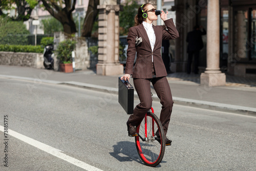 portrait of businesswoman with unicycle photo