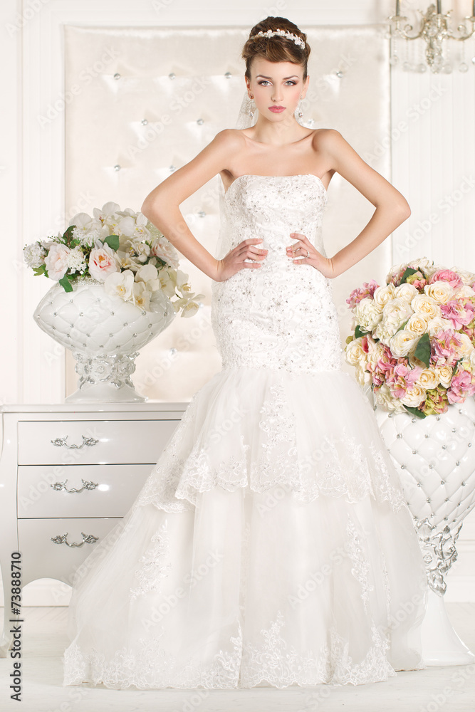 Gorgeous bride with white dress with flowers bouquet