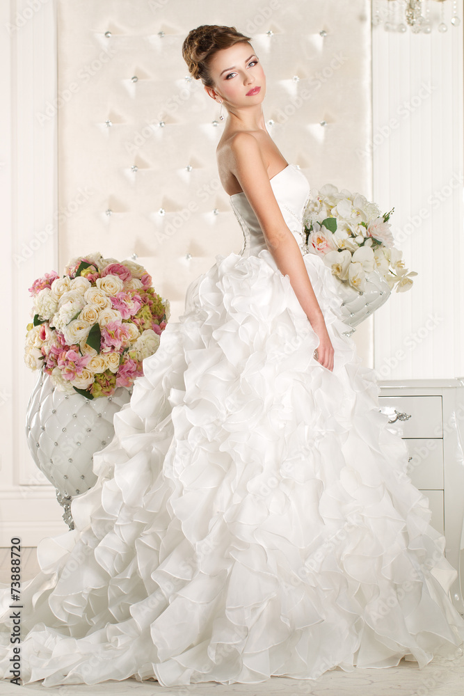 Gorgeous bride with white dress with flowers bouquet Gorgeous bride with white dress with flowers bouquet