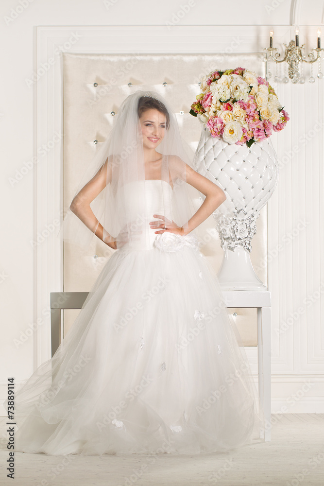 Gorgeous bride with white dress with flowers bouquet Gorgeous bride with white dress with flowers bouquet