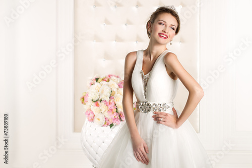 Gorgeous bride with white dress with flowers bouquet