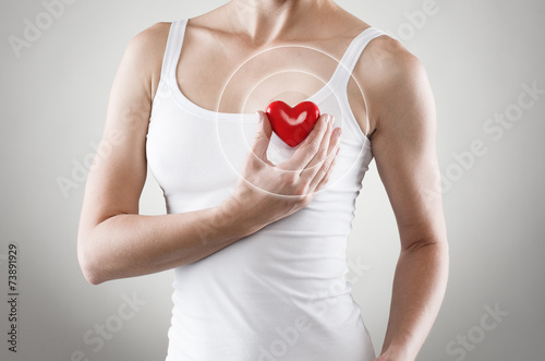 Heart shape in woman's hands. Cardiovascular medicine photo
