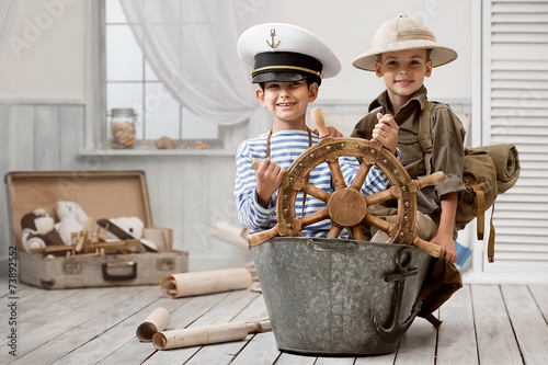 Boys playing captain and traveler photo