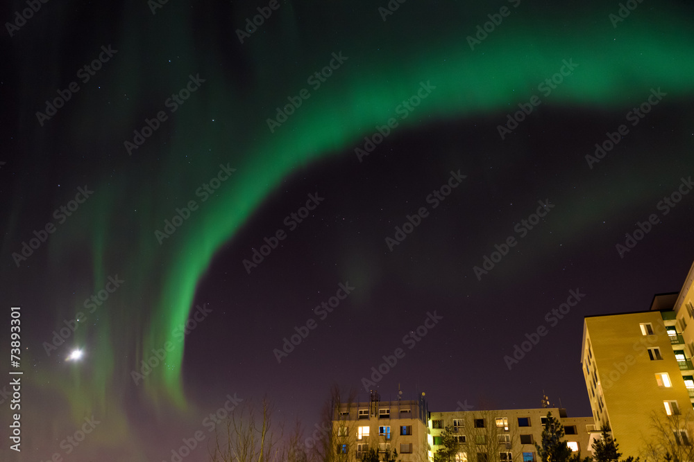 Aurora borealis over city buildings