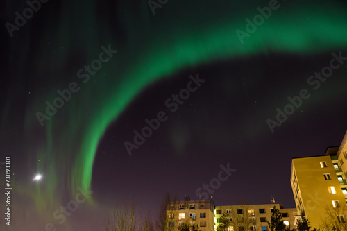 Fototapeta Naklejka Na Ścianę i Meble -  Aurora borealis over city buildings
