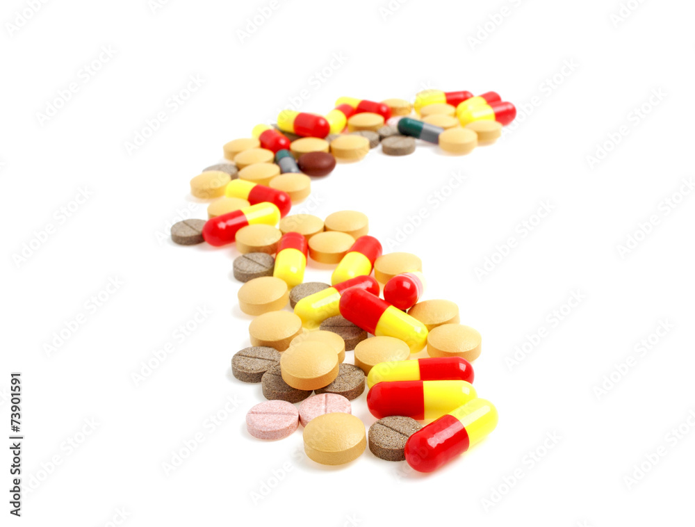Colored pills and tablets on a white background