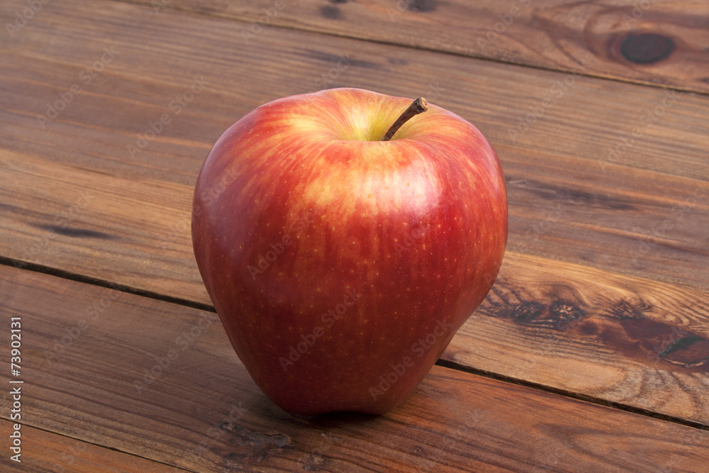 Red apple on rustic wooden background Red apple on rustic wooden background