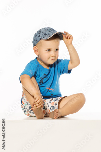 Smiling happy boy in baseball cap photo