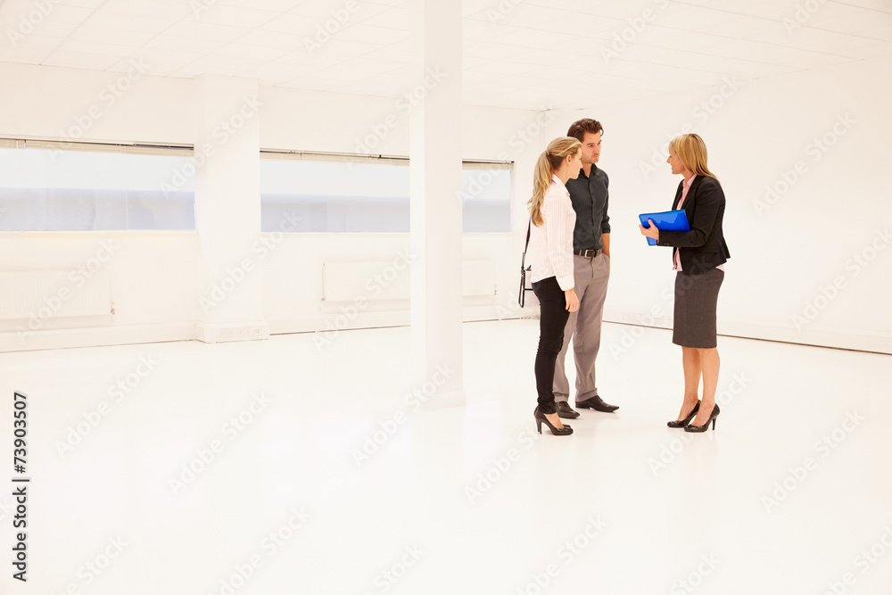 Fototapeta premium Estate Agent Showing Empty Office Space To Potential Clients