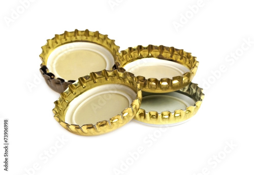Metallic crown caps on a white background