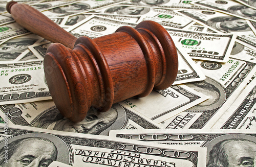 Wooden gavel and American dollars photo