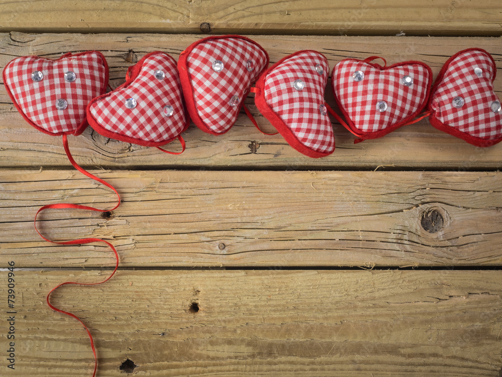 red check hearts on rustic wooden background