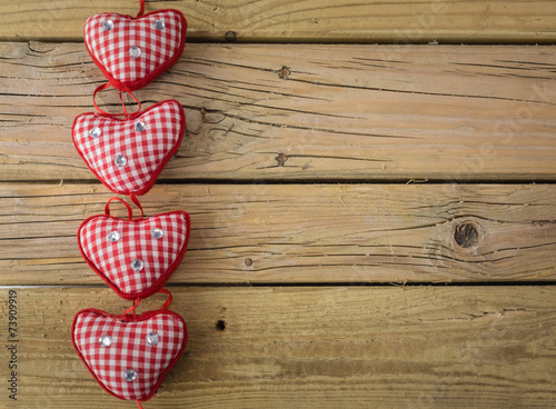 red check hearts on rustic wooden background