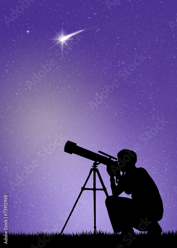 Man looks in the telescope photo