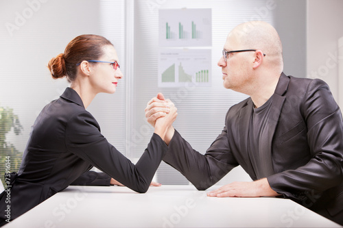 woman vs man business arm wrestling photo