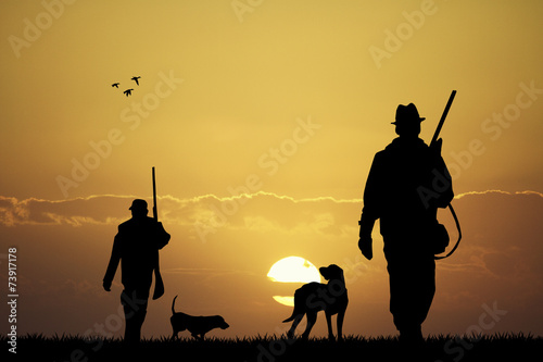 Leinwand Poster Jäger bei Sonnenuntergang