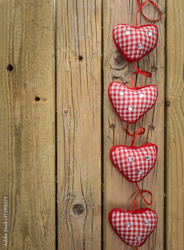 red check hearts on rustic wooden background