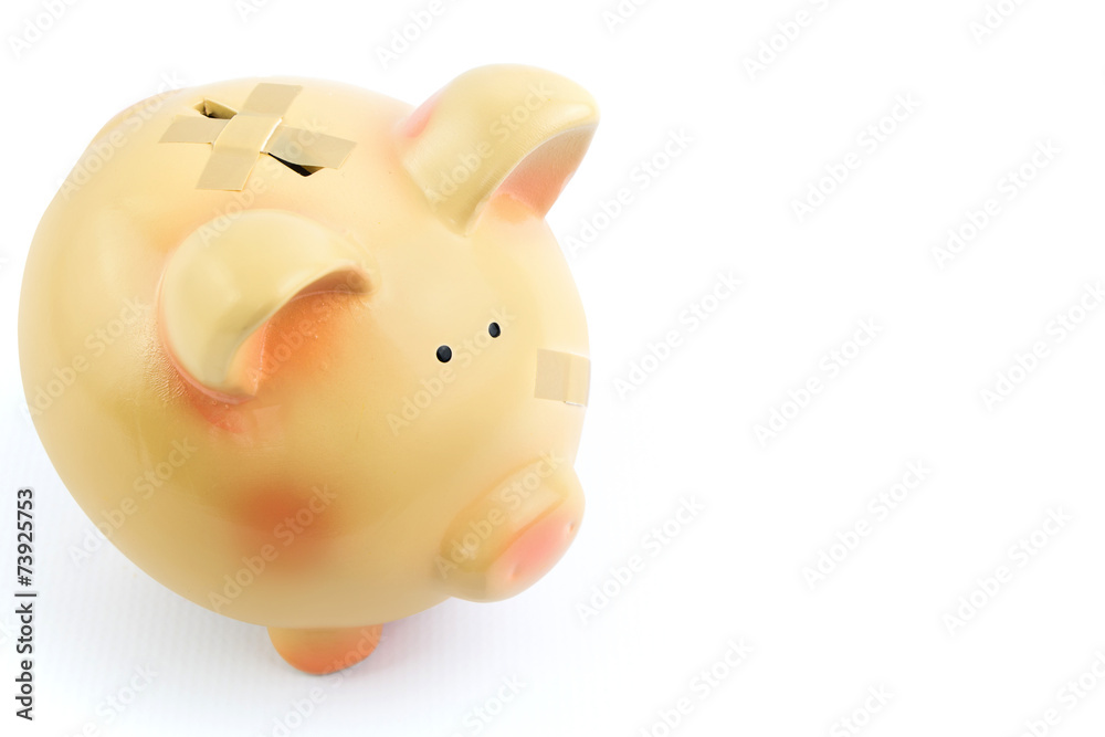 Piggy bank with medical patches, isolated on white background Piggy bank with medical patches, isolated on white background