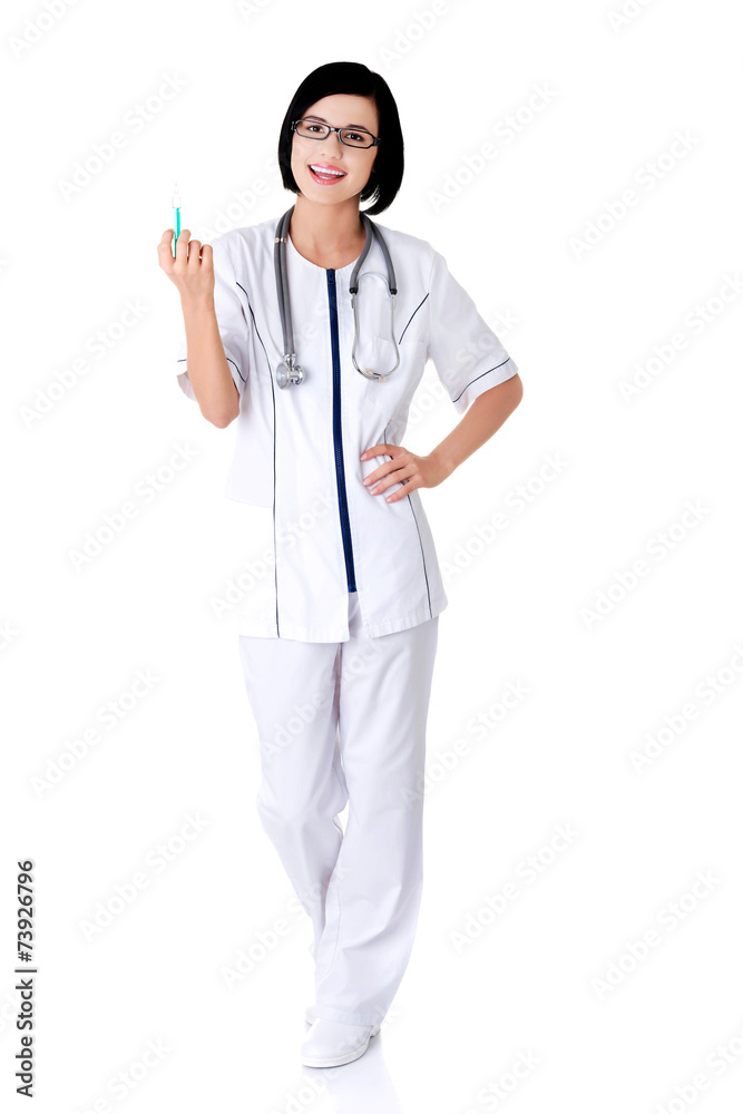 Full length female doctor holding syringe Full length female doctor holding syringe