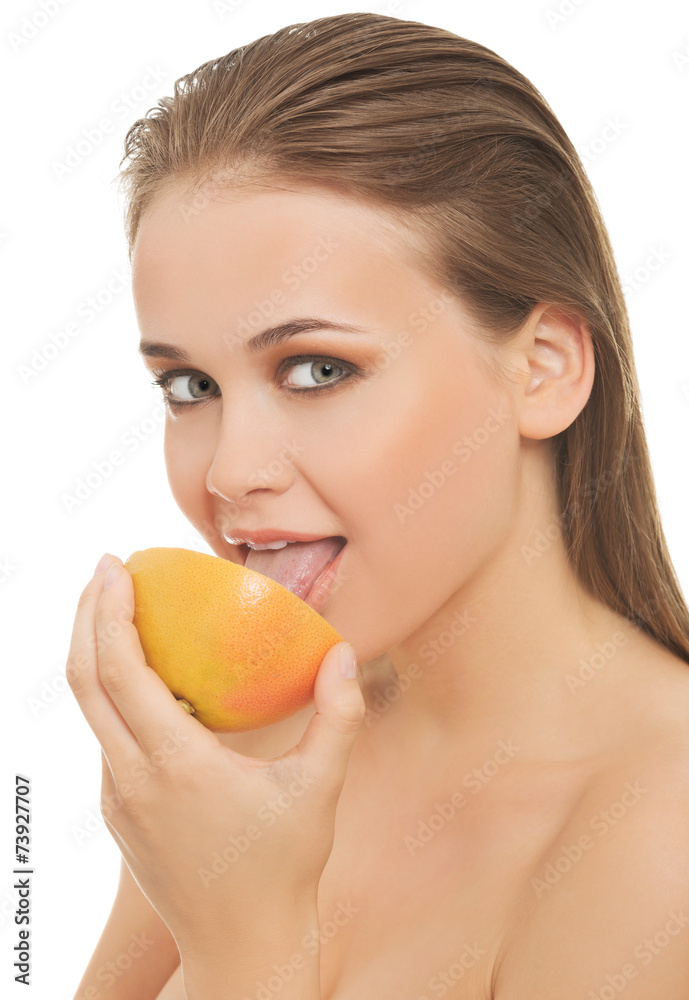 Young nude woman eating grapefruit Young nude woman eating grapefruit