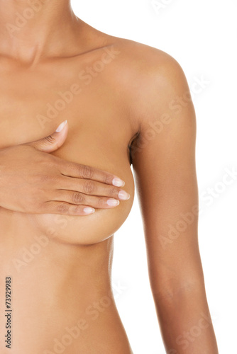 Close up of nude woman covering breast