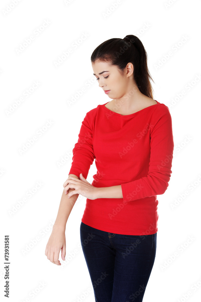 Young beautiful woman scraching herself