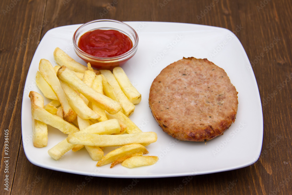 Hamburger with fries and ketchup on wooden table
