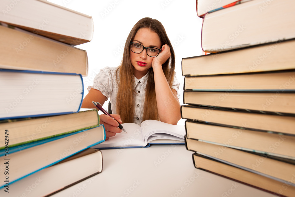Stressed asian caucasian woman student learning in tons of books Stressed asian caucasian woman student learning in tons of books