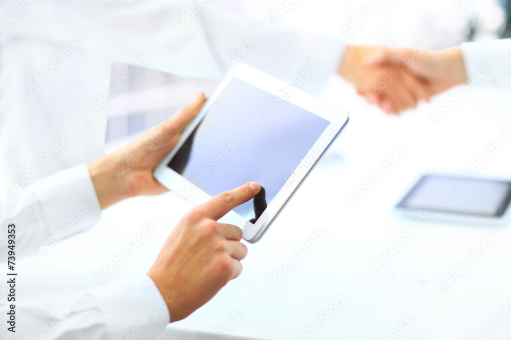 Business associates shaking hands in office Business associates shaking hands in office