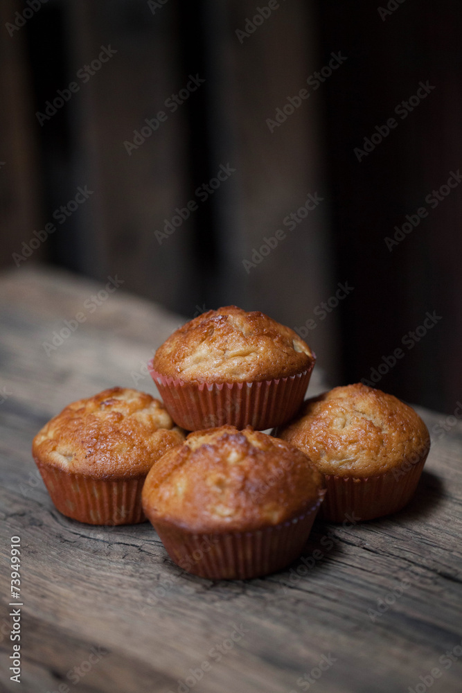delicious homemade muffins over wooden board delicious homemade muffins over wooden board