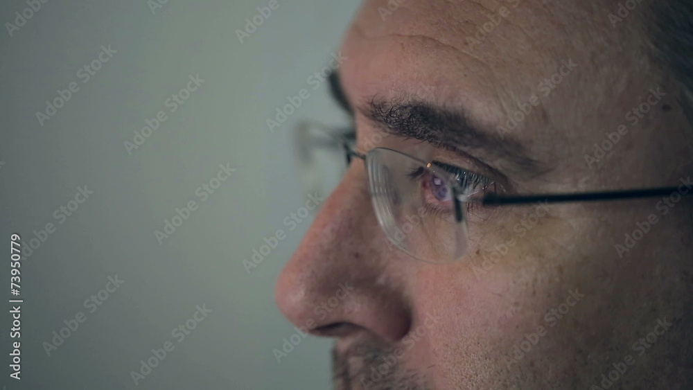 Close up middle-aged man working on a computer Macro lens Close up middle-aged man working on a computer Macro lens