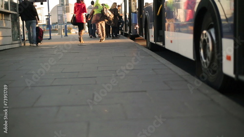 People waiting for the bus and embus on the station