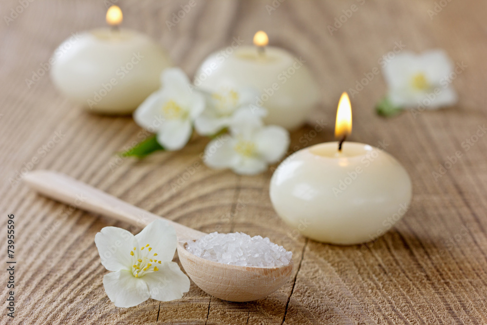 Spa composition with sea salt bath, jasmine flowers and candles