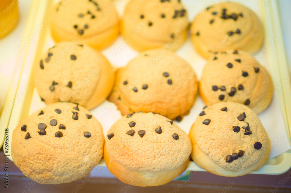 Bunch of cookies with chocolate stew on shelf in supermarket
